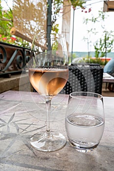 Summer on French Riviera Cote d`Azur, drinking cold rose  wine from Cotes de Provence on outdoor terrase in cafe