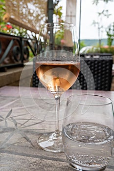 Summer on French Riviera Cote d`Azur, drinking cold rose  wine from Cotes de Provence on outdoor terrase in cafe