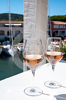Summer on French Riviera Cote d`Azur, drinking cold rose wine from Cotes de Provence on outdoor terrase in Port Grimaud, Var,