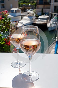 Summer on French Riviera Cote d`Azur, drinking cold rose wine from Cotes de Provence on outdoor terrase in Port Grimaud, Var,