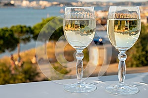 Summer on French Riviera, drinking cold white wine from Cotes de Provence on outdoor terrase with view on harbour of Toulon, Var,