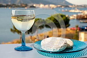 Summer on French Riviera, drinking cold white wine from Cotes de Provence on outdoor terrase with view on harbour of Toulon, Var,