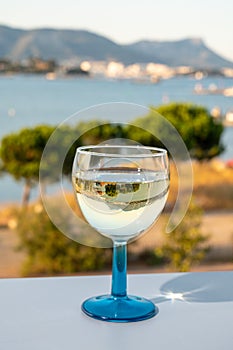 Summer on French Riviera, drinking cold white wine from Cotes de Provence on outdoor terrase with view on harbour of Toulon, Var,