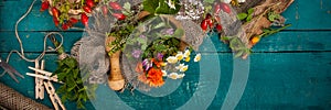 Summer fresh medicinal herbs on the wooden background.