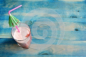 Summer fruit cocktail on blue wooden background