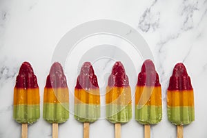 Summer fruit ice lolly popsicle on a marble background