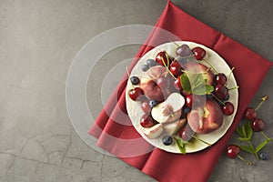 Summer fruit mix - cherry, blueberry, peach. Fruit salad plate. Flat lay with copy space