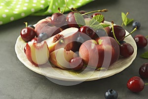 Summer fruit mix - cherry, blueberry, peach. Fruit salad plate. Flat lay with copy space