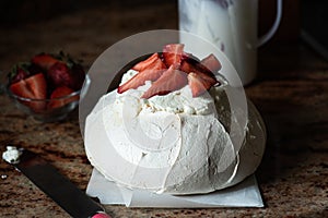 Summer fruit Pavlova with cream cheese filling and strawberries on a table. Life style photography