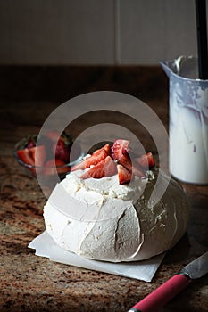 Summer fruit Pavlova with cream cheese filling and strawberries on a table. Life style photography