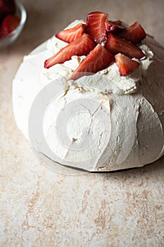 Summer fruit pavlova - famous Australian dessert from baked whipped egg whites and cream cheese filling with strawberries