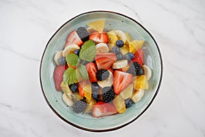 Summer Fruit salad with oranges, strawberries, blueberries, blackberries and fresh mint. Healthy food