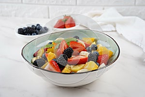 Summer Fruit salad with oranges, strawberries, blueberries, blackberries and fresh mint. Healthy food