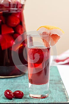 Summer fruit wine, sangria cocktail in small glass and jugful