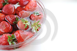 Summer fruits. Home strawberry in bowl with water with copy space