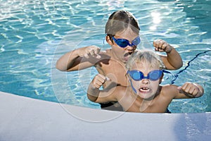 Summer fun, boys playing in swimming pool