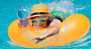 Summer fun kids face. Kid boy relaxing in pool swim on float ring. Child swimming in water pool. Summer kids activity