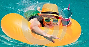 Summer fun kids face. Kid boy relaxing in pool swim on float ring. Child swimming in water pool. Summer kids activity