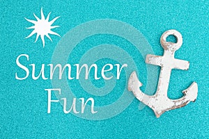 Summer fun message on weathered anchor on a turquoise glitter paper