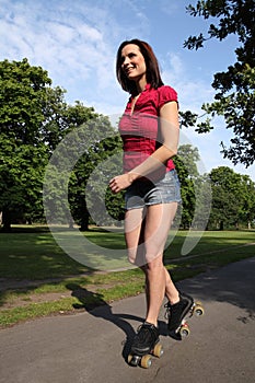 Summer fun long legged woman roller skating