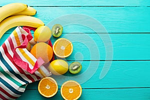 Summer fun time and fruits on blue wooden background. Mock up and picturesque. Orange, lemon, kiwi, banana fruit on table. Top vie