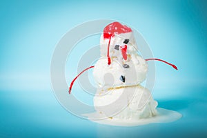 summer funny creative concept of melting scoops ice cream snowman on blue background