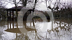 the summer gazebo in the park is flooded with water. photo