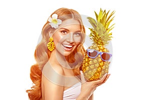 Summer girl Bright woman with a pineapple in her hands with earrings in the form of a tropical leaf, with sun glasses on a white