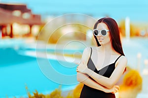 Summer Girl with Fashion Sunglasses and Black Swimsuit by the Pool