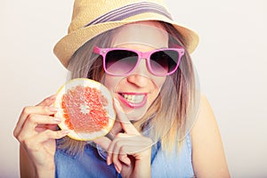 Summer girl holding grapefruit