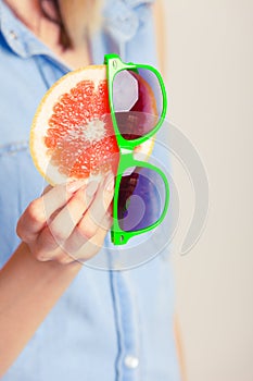 Summer girl holding grapefruit