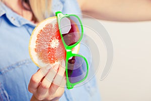 Summer girl holding grapefruit