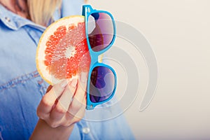 Summer girl holding grapefruit