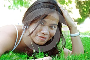 Summer girl lying over grasses