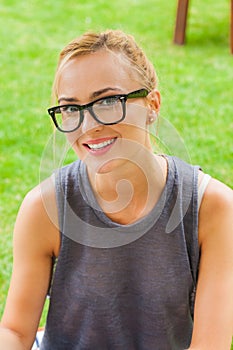Summer girl portrait. Caucasian blonde woman smiling happy on sunny summer or spring day outside in park