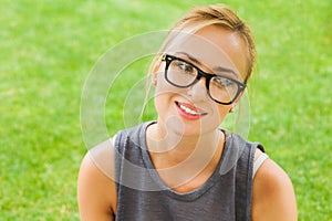 Summer girl portrait. Caucasian blonde woman smiling happy on sunny summer or spring day outside in park