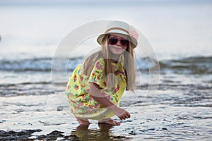 Summer girl portrait. Caucasian little girl smiling happy on sunny summer or spring day outside in park by lake. Pretty girl