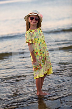 Summer girl portrait. Caucasian little girl smiling happy on sunny summer or spring day outside in park by lake. Pretty girl