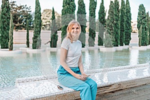 Summer girl portrait. Caucasian woman smiling happy on sunny summer or spring day outside in park by lake.