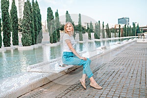 Summer girl portrait. Caucasian woman smiling happy on sunny summer or spring day outside in park by lake.