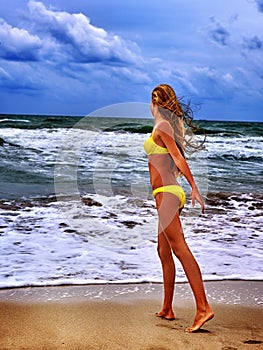 Summer girl sea in yellow swimsuit