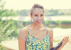 Summer girl. Smiling woman on sunny day outside in park by lake.