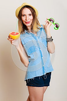 Summer girl tourist holding grapefruit citrus fruit