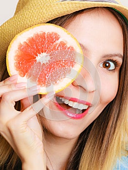 Summer girl tourist holding grapefruit citrus fruit