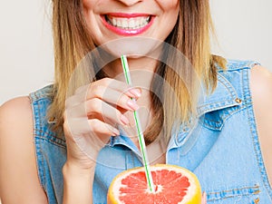 Summer girl tourist holding grapefruit citrus fruit