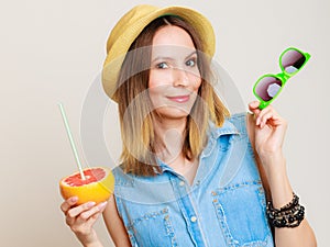 Summer girl tourist holding grapefruit citrus fruit