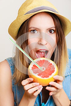 Summer girl tourist holding grapefruit citrus fruit