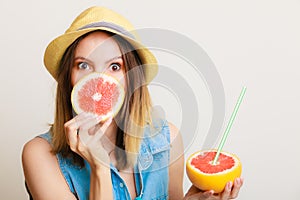 Summer girl tourist holding grapefruit citrus fruit