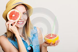 Summer girl tourist holding grapefruit citrus fruit