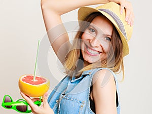 Summer girl tourist holding grapefruit citrus fruit